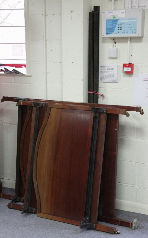 A pair of mahogany bed ends with arch tops and inlaid chequer banding and a wardrobe, 165cm (65")