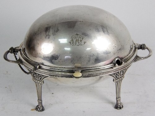 A Victorian breakfast heater, the revolving cover on a stand with four fluted legs with claw feet