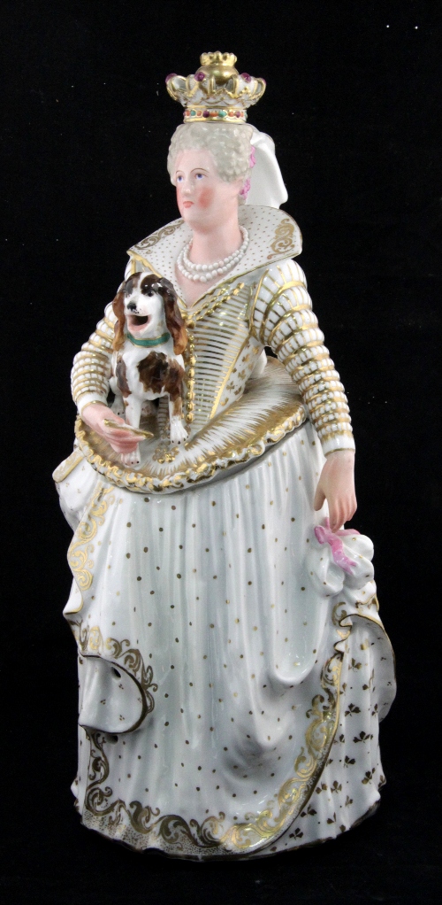 A porcelain jug modelled as the Queen Catherine of Medici wearing a crown and holding a spaniel,