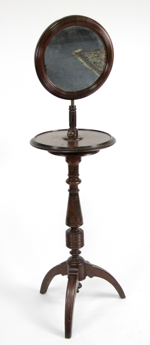 A Victorian mahogany shaving stand with circular adjustable mirror on turned column and tripod