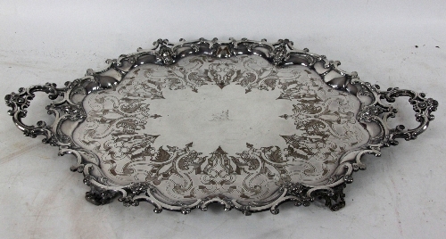 A large plated tray of scrolling outline, with scrolling handles, central crest and mask details,