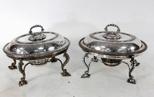 A pair of silver plated warming dishes, the oval dishes with beaded handles and borders on a stand