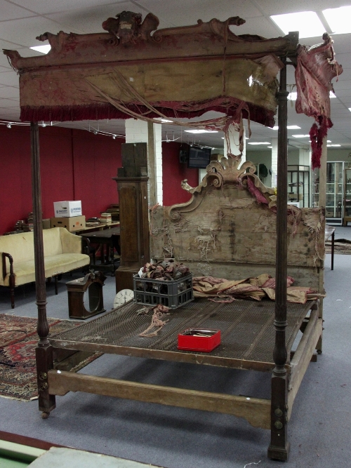 A tester bed, the end columns of leaf capped reeded form, the headboard with coronet and scrolling