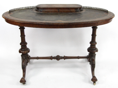 A Victorian walnut writing table, the oval top with hinged stationery compartment on turned  end