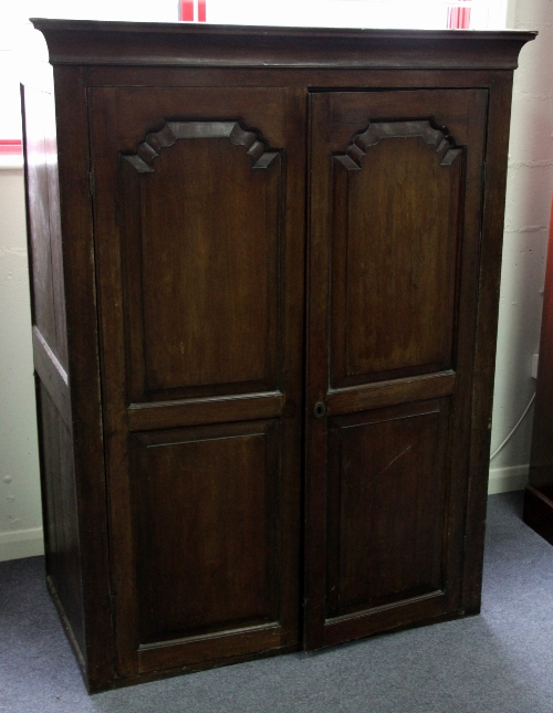 A Welsh mahogany cabinet with fielded panel doors, 165cm (65") high, 122cm (48") wide