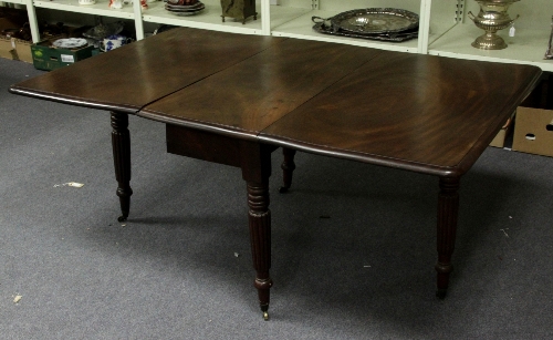 A William IV mahogany dropleaf table, the rectangular top and flaps on turned and reeded legs with