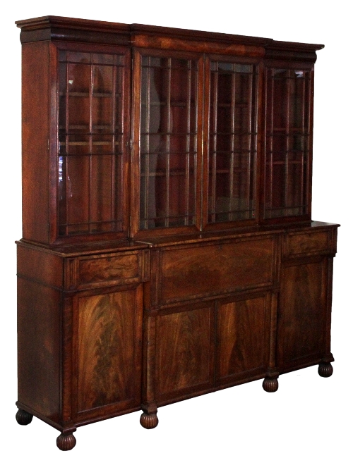 A George IV mahogany breakfront bookcase, the centre section with astragal glazed doors above a