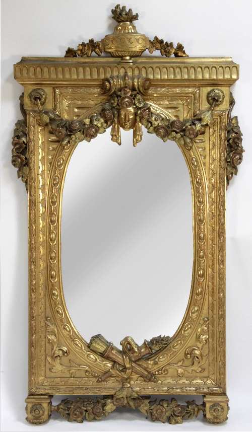 A 19th Century French carved wood and gilt gesso mirror, crested with urn and set with two floral