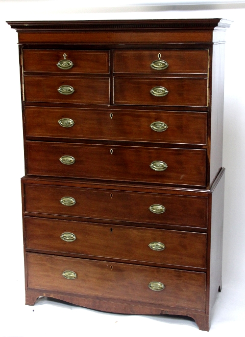 A mahogany chest in two sections, the top with false drawer front cupboard and two drawers