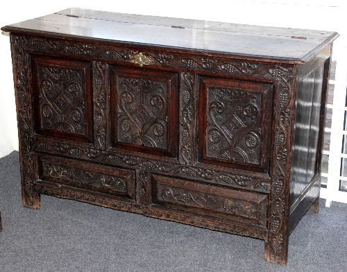 An 18th Century style oak mule chest with later carved panels and drawer fronts, 137cm (54") wide