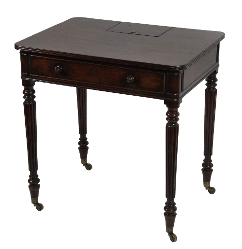 A 19th Century mahogany writing table to a design by Gillows, with hinged lidded compartment