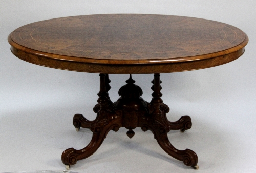 A Victorian walnut loo table, the oval top with boxwood banding and very fine burr veneer on four