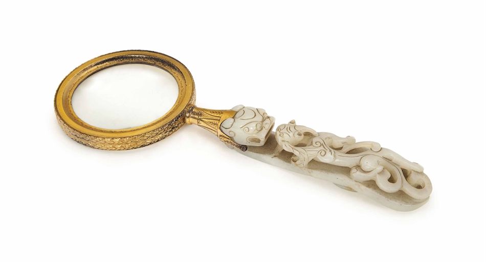 A CHINESE HARDSTONE ROBE HOOK LATER SILVER-GILT MOUNTED AS A MAGNIFYING GLASS,
THE MOUNTS FIRST