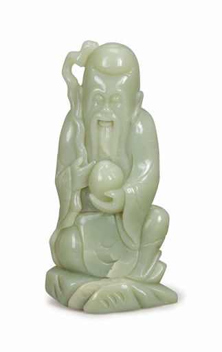 A CHINESE CARVED CELADON JADE FIGURE OF A SAGE, 
carved with a staff and peach atop a rock 
6½in. (