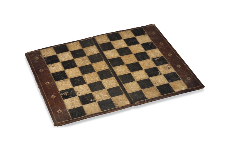 A GILT-TOOLED LEATHER FOLDING GAMES BOARD
18TH CENTURY
Open -- 16 x 19.7/8 in. (40.5 x 50.5 cm.)