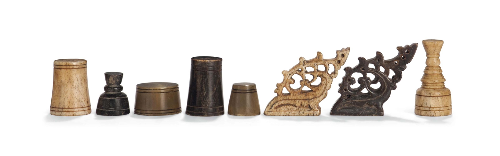 A SOUTH EAST ASIAN HORN AND BONE CHESS SET
PHILIPPINES, MID-19TH CENTURY
Of abstract form, the