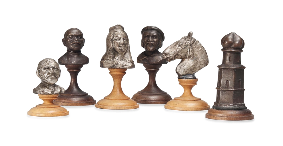 A RUSSIAN BRONZE AND SILVERED BUST TYPE CHESS SET
EARLY 20TH CENTURY
On turned fruitwood and boxwood