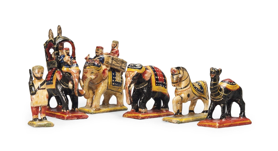 A NORTH INDIAN CARVED AND POLYCHROME CHESS SET
FIRST HALF 20TH CENTURY
The king and queen modelled