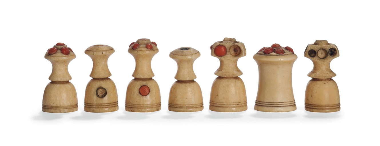 SEVEN CORAL-MOUNTED MARINE IVORY MUSLIM TYPE CHESS PIECES
POSSIBLY EGYPTIAN, 19TH CENTURY
Of