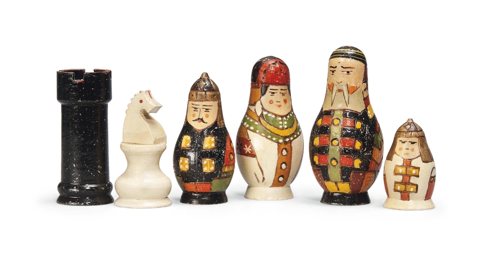 A RUSSIAN LACQUERED WOOD FIGURAL CHESS SET
EARLY 20TH CENTURY
The pieces modelled as Russian