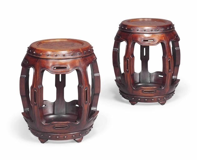 A PAIR OF CHINESE ROSEWOOD LOW STANDS 
FIRST HALF 20TH CENTURY 
Of barrel form, each with a solid