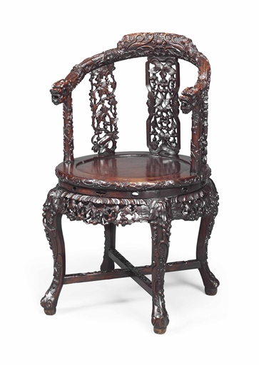 A CHINESE HONGMU ARMCHAIR 
QING DYNASTY (1644-1912), CIRCA 1900 
Profusely carved overall with