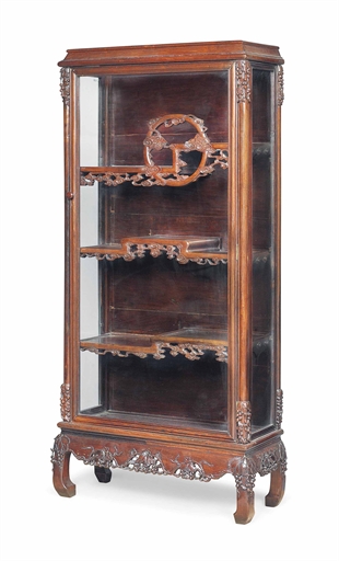 A CHINESE ROSEWOOD DISPLAY CABINET 
QING DYNASTY (1644-1912), CIRCA 1900 
With a glazed top, door
