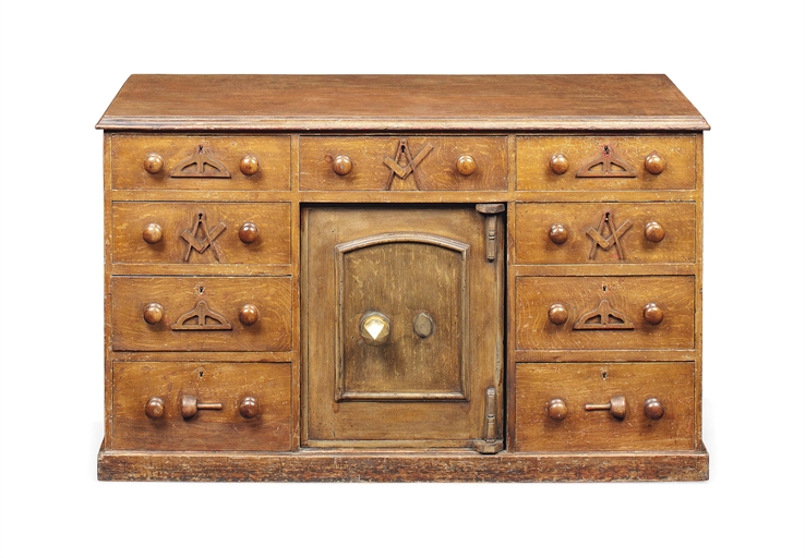 A VICTORIAN SIMULATED OAK MASONIC TREASURER'S DESK 
THIRD QUARTER 19TH CENTURY 
With nine drawers