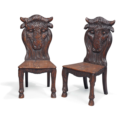 A PAIR OF CARVED MAHOGANY HALL CHAIRS 
LATE 19TH  EARLY 20TH CENTURY 
Each modelled as a bison, with