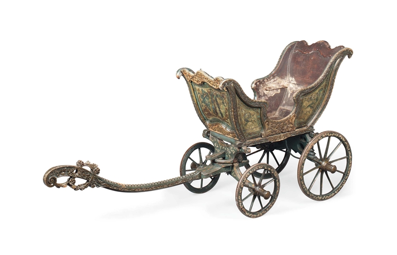 A RARE ITALIAN CARVED AND POLYCHROME DECORATED CHILD'S CARRIAGE 
DATED 1769 
The open carriage