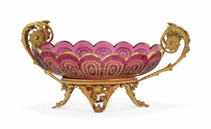 A GILT-METAL-MOUNTED CRANBERRY GLASS BOWL 
20TH CENTURY 
With scalloped rim, the sides gilt with