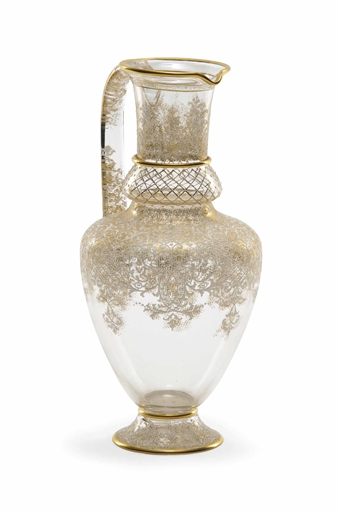 A LOBMEYR ENAMELLED GLASS JUG 
CIRCA 1890, WHITE ENAMEL MARK 
Enamelled in white with scrolling