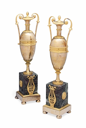 A PAIR OF EMPIRE GILT-BRONZE URNS 
EARLY 19TH CENTURY 
Each of twin-handled form, on rectangular