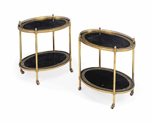 A PAIR OF ENGLISH BRASS AND GILT-TOOLED BLACK LEATHER TWO-TIER OVAL ETAGERES
CIRCA 1955, PROBABLY