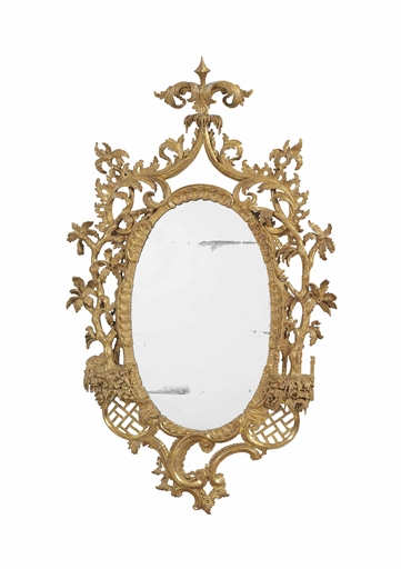 A GEORGE II GILTWOOD MIRROR 
CIRCA 1755, IN THE MANNER OF THOMAS JOHNSON 
The oval plate within a