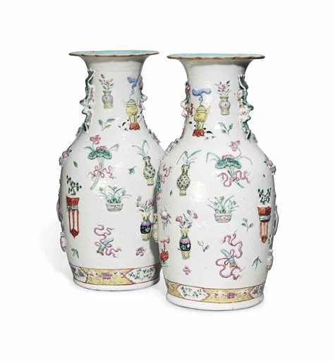 A PAIR OF CHINESE FAMILLE ROSE MOULDED BALUSTER VASES 
19TH CENTURY 
Each with two Buddhist lion and