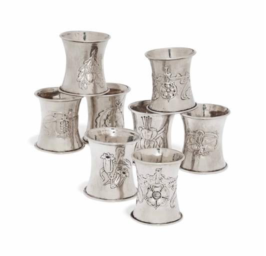 A SET OF SEVEN SILVER NAPKIN RINGS 
MARK OF RAMSDEN AND CARR, LONDON, 1903 
Each waisted with