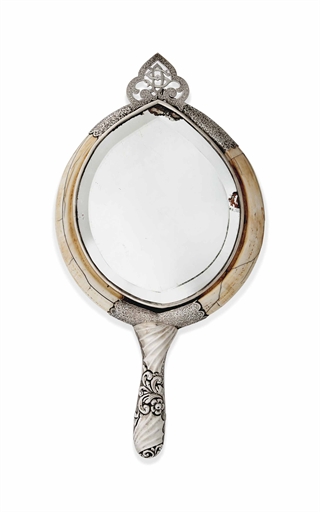 A LATE VICTORIAN SILVER-MOUNTED IVORY BOAR TUSK HAND MIRROR 
MARK OF G. LOVERIDGE AND CO.,