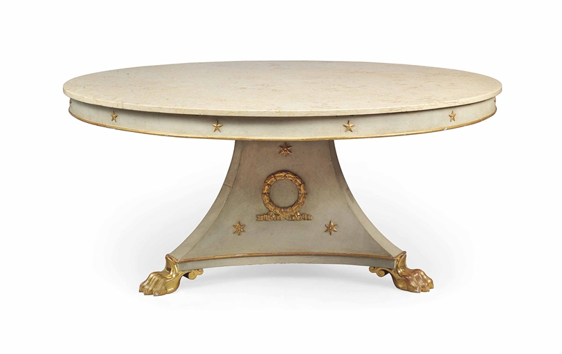 AN EMPIRE-STYLE PARCEL-GILT AND CREAM-PAINTED CIRCULAR DINING-TABLE 
MODERN 
The polished