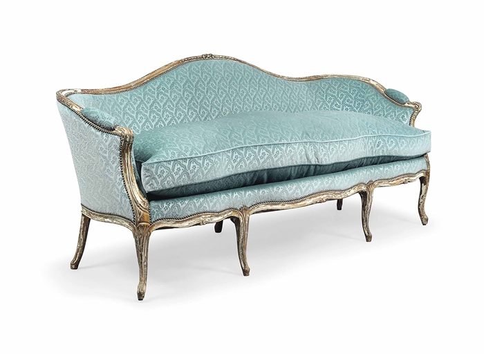 A GEORGE III PARCEL-GILT AND WHITE-PAINTED SOFA 
CIRCA 1770 
The channelled frame with arched