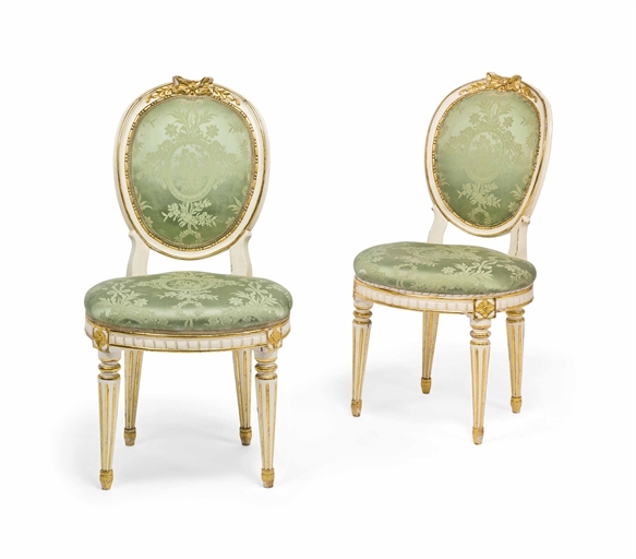 A PAIR OF SWEDISH PARCEL-GILT AND WHITE-PAINTED SIDE CHAIRS 
LATE 19TH CENTURY 
Each medallion-