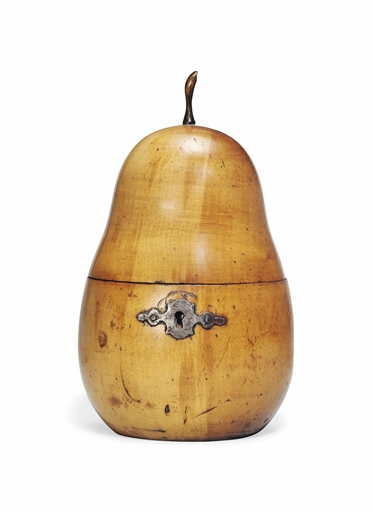 A GEORGE III FRUITWOOD PEAR-FORM TEA CADDY 
CIRCA 1800 
With iron shaped escutcheon 
7 in. (18