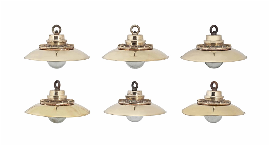 SIX BRASS HANGING YACHT LIGHTS 
MID-20TH CENTURY 
Each with hanging loop and domed glass shade, with