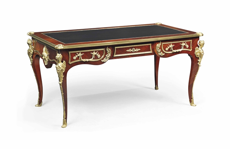 A FRENCH GILT-METAL MOUNTED MAHOGANY AND TULIPWODO CROSSBANDED BUREAU PLAT
OF LOUIS XV STYLE,