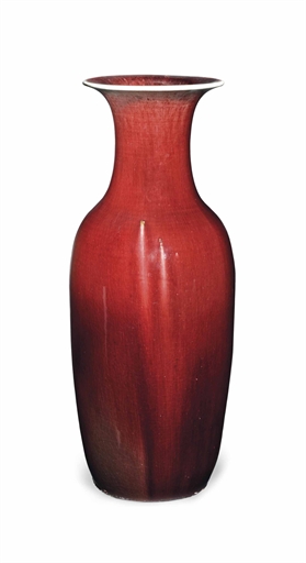A CHINESE FLAMBÉ-GLAZED BALUSTER VASE 
19TH CENTURY 
With flaring neck, covered in a deep red