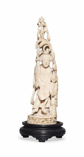 A CHINESE IVORY GROUP 
18TH/19TH CENTURY 
Carved and pierced as a lady wearing long flowing robes