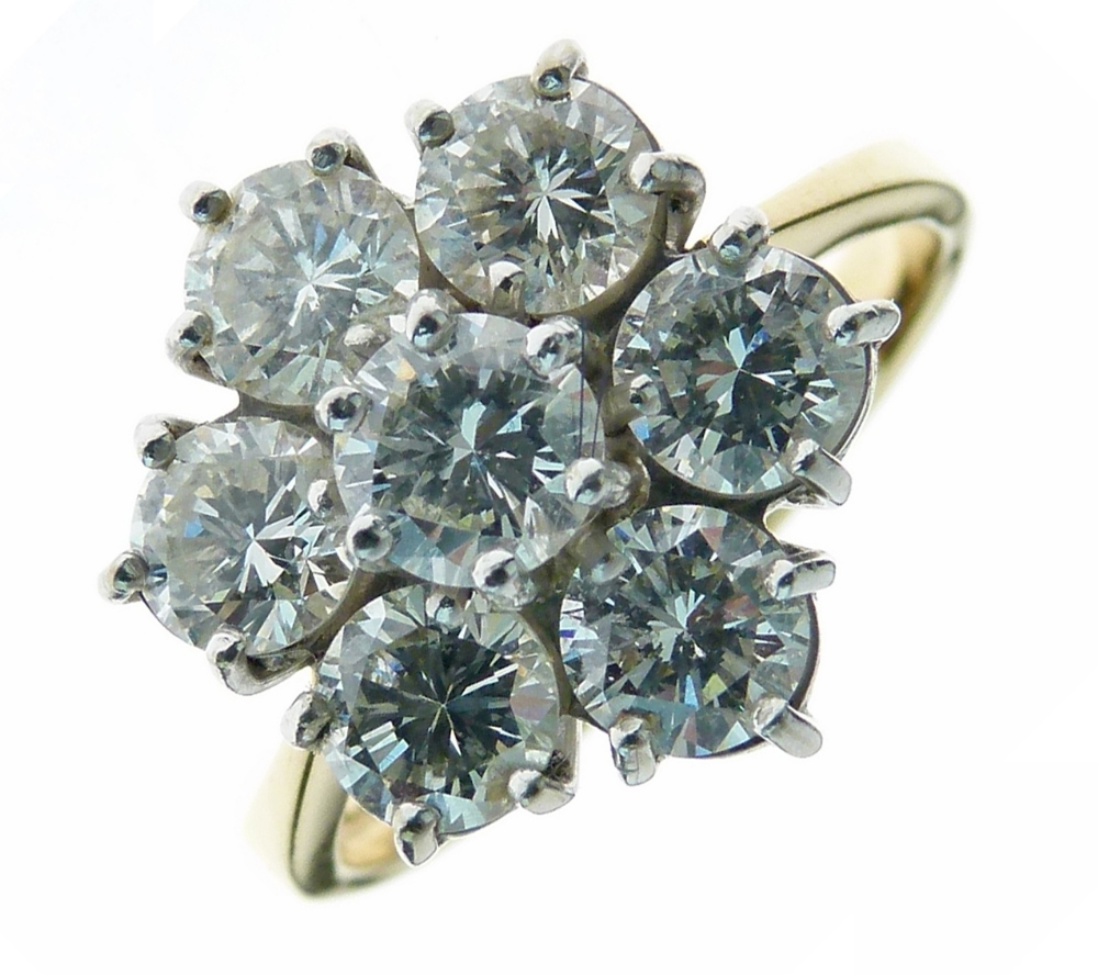 Seven stone diamond cluster ring, to an 18ct import hallmarked yellow gold mount, London 1989, the