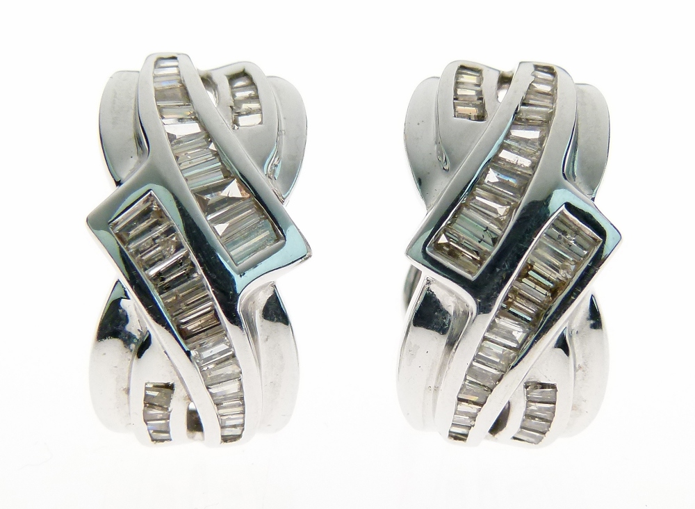 Pair of diamond 18ct white gold earrings, London 1999 of crossover design, each set with