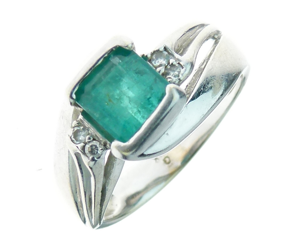 Diamond and emerald ring, the square step cut stone 6mm square, flanked either side by pairs of