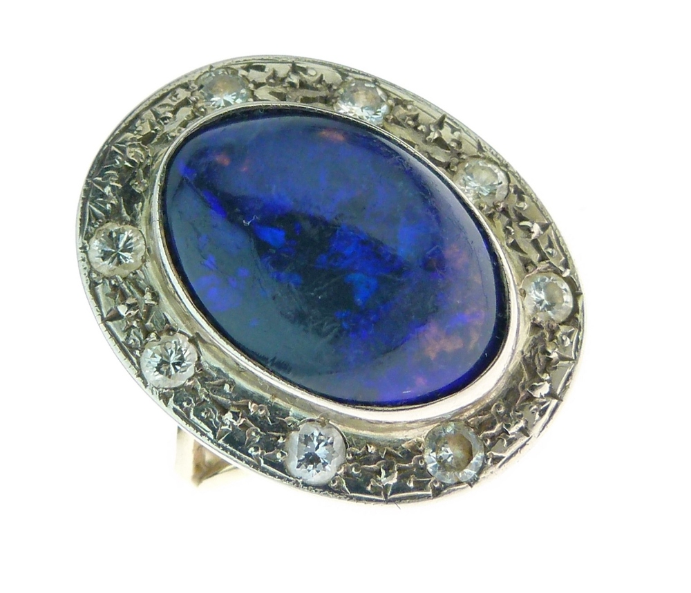 Black opal and diamond cluster ring, the oval cabochon 15mm long, of predominately blue colour play,